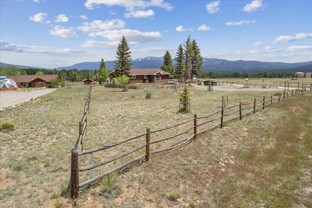 view of yard with a mountain view and a rural view