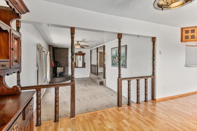 interior space with a textured ceiling, light hardwood / wood-style flooring, and vaulted ceiling