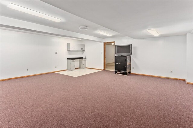 basement featuring light carpet