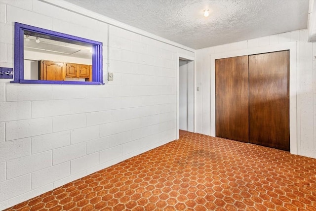 unfurnished bedroom featuring a closet and a textured ceiling