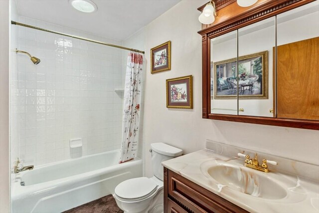 full bathroom featuring vanity, shower / bath combo, and toilet