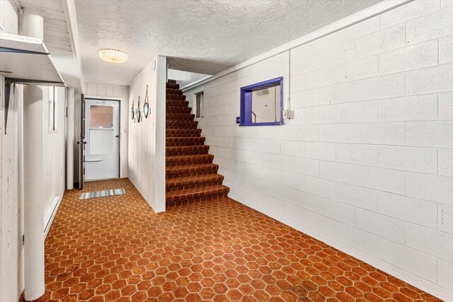 basement featuring a textured ceiling