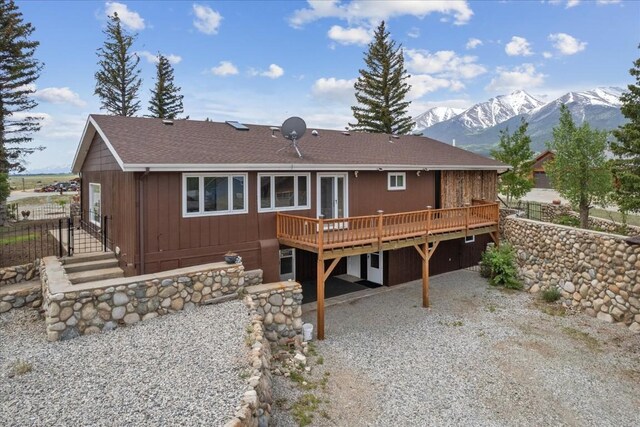 rear view of house featuring a deck with mountain view