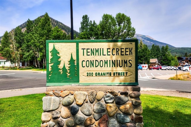 community sign with a mountain view