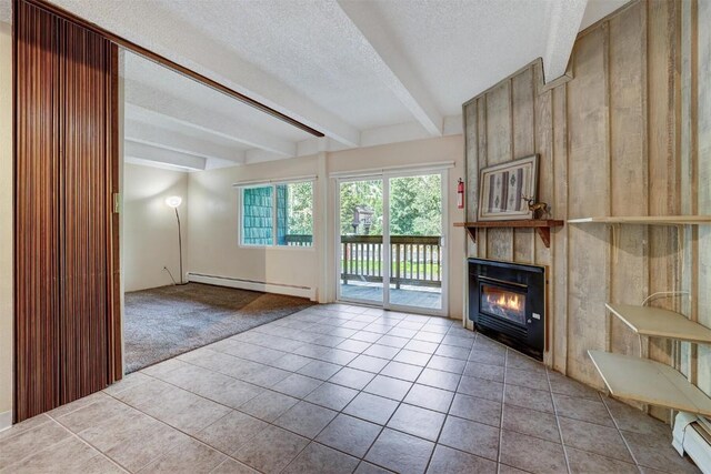 unfurnished living room featuring beamed ceiling, a fireplace, baseboard heating, and a textured ceiling