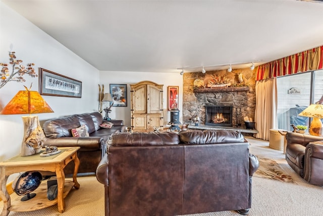 carpeted living room with a fireplace and rail lighting