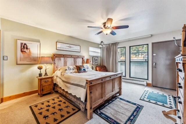 bedroom with access to exterior, light carpet, ceiling fan, and a baseboard heating unit