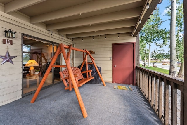 basement featuring wood walls and dark carpet