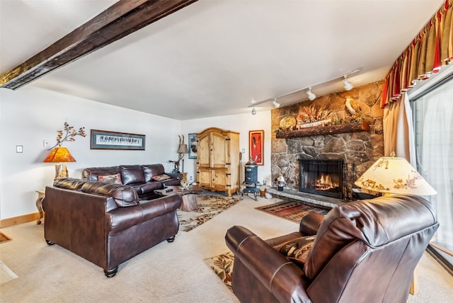 carpeted living room featuring a fireplace and track lighting