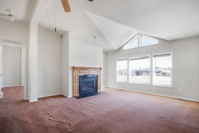 unfurnished living room with a ceiling fan, visible vents, baseboards, a fireplace, and carpet flooring