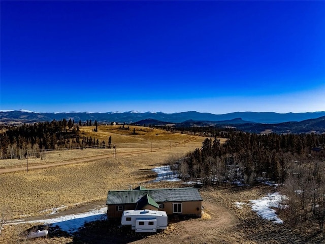 birds eye view of property featuring a mountain view and a rural view