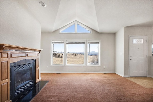 carpeted living area featuring a fireplace with flush hearth, baseboards, and vaulted ceiling