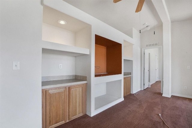 kitchen with visible vents, open shelves, light countertops, a ceiling fan, and dark colored carpet