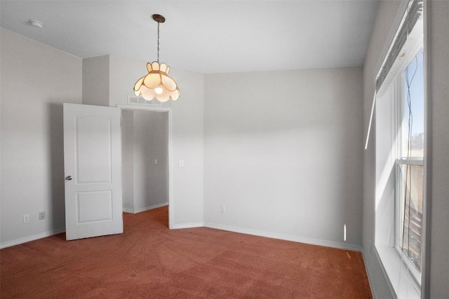 carpeted empty room with a healthy amount of sunlight and baseboards