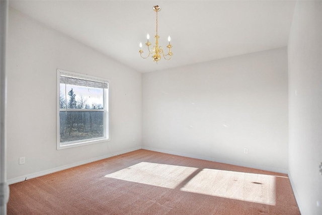 spare room with vaulted ceiling, a notable chandelier, baseboards, and carpet floors