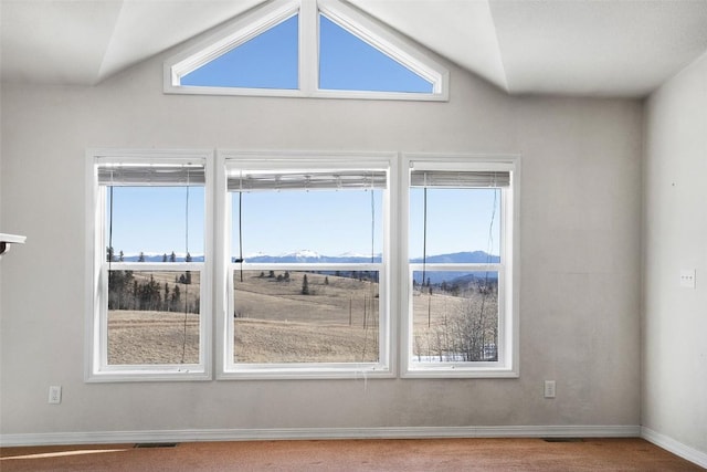 spare room featuring vaulted ceiling, baseboards, and visible vents