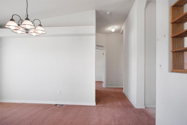 unfurnished dining area featuring a notable chandelier, carpet, visible vents, and baseboards