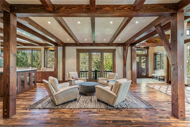 living room featuring beamed ceiling and hardwood / wood-style floors