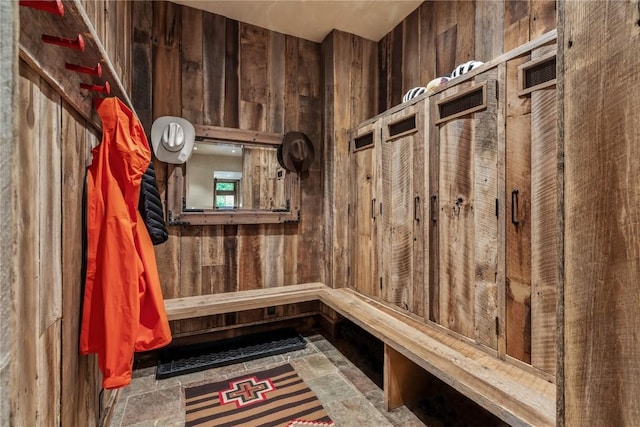 mudroom with wood walls