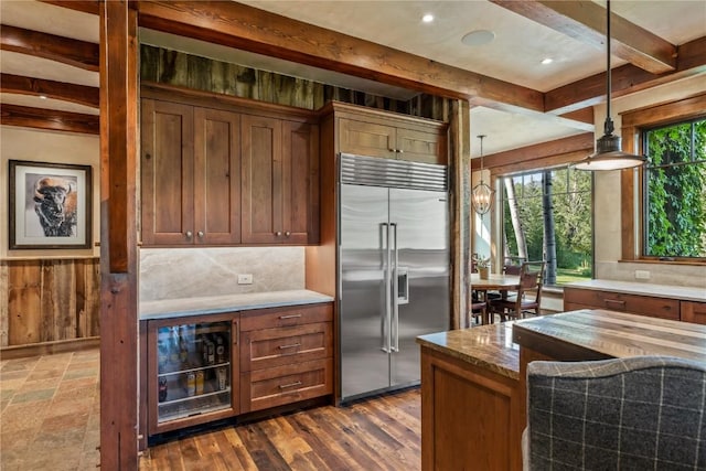 kitchen with backsplash, beam ceiling, decorative light fixtures, beverage cooler, and stainless steel built in fridge