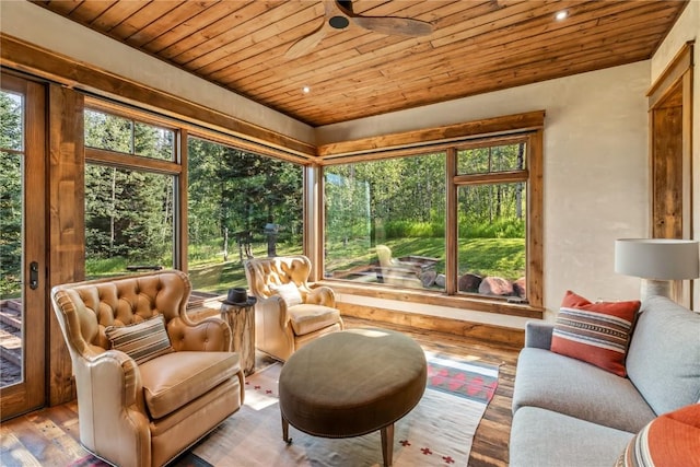 sunroom featuring wooden ceiling and ceiling fan