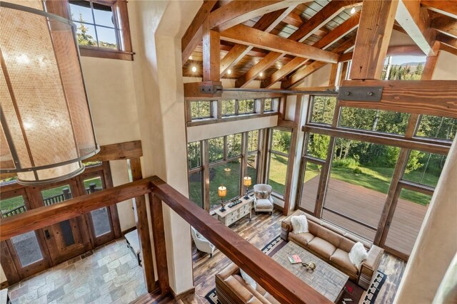 interior space with beam ceiling and high vaulted ceiling