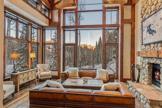 sunroom with a stone fireplace