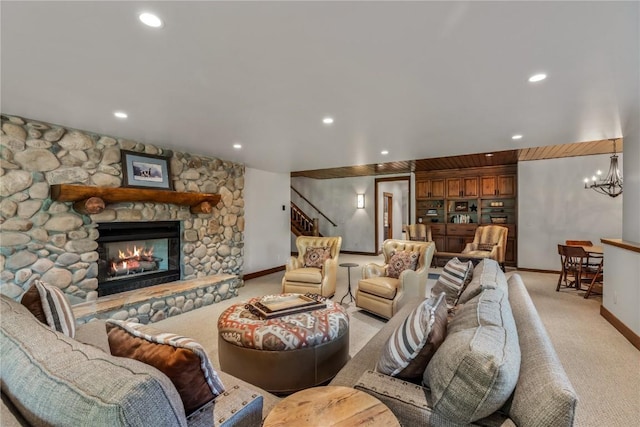 living room featuring an inviting chandelier, light colored carpet, and a fireplace