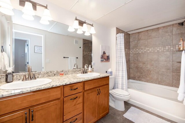 full bathroom featuring tile patterned flooring, vanity, shower / bath combination with curtain, and toilet