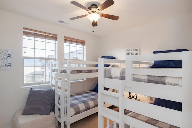 bedroom with ceiling fan and multiple windows