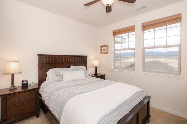 bedroom with light colored carpet and ceiling fan