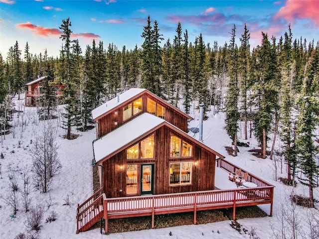 view of snow covered back of property