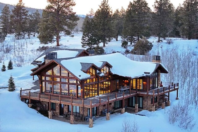 view of snow covered back of property