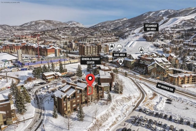 snowy aerial view with a mountain view