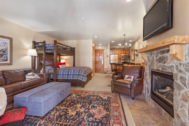 living area with an inviting chandelier, a fireplace, and recessed lighting