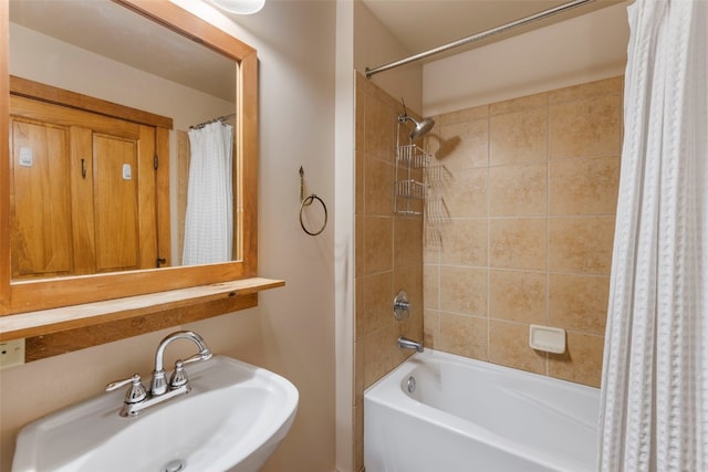 bathroom featuring a sink and shower / bathtub combination with curtain