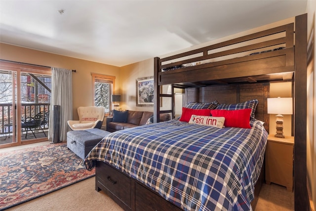 bedroom featuring light carpet and access to outside