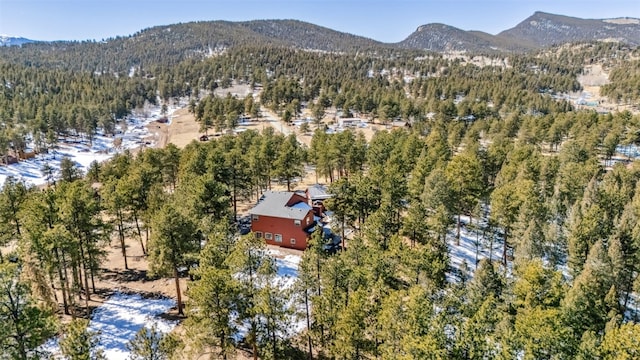 aerial view with a mountain view and a wooded view