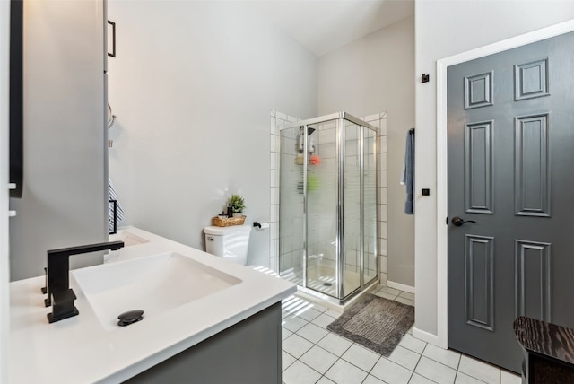 full bath featuring a stall shower, tile patterned flooring, baseboards, and a sink