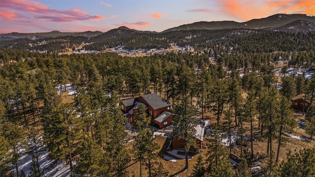 birds eye view of property featuring a mountain view and a forest view