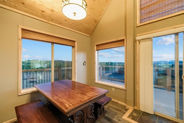 dining area with dark hardwood / wood-style floors, wood ceiling, and vaulted ceiling