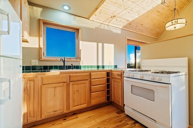 kitchen featuring tile counters, sink, wooden ceiling, vaulted ceiling, and white appliances