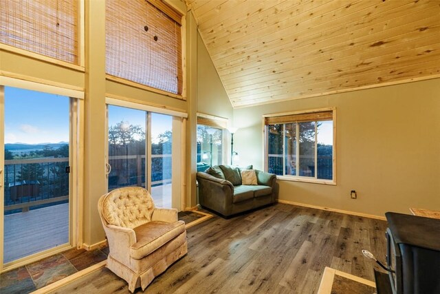 sunroom featuring lofted ceiling and wooden ceiling