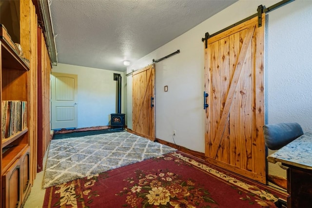 bedroom featuring a textured ceiling and a barn door