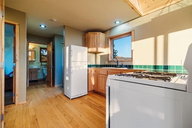 kitchen featuring light hardwood / wood-style floors, white appliances, sink, and light brown cabinets