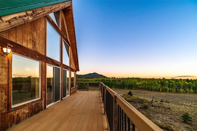 deck at dusk featuring a mountain view