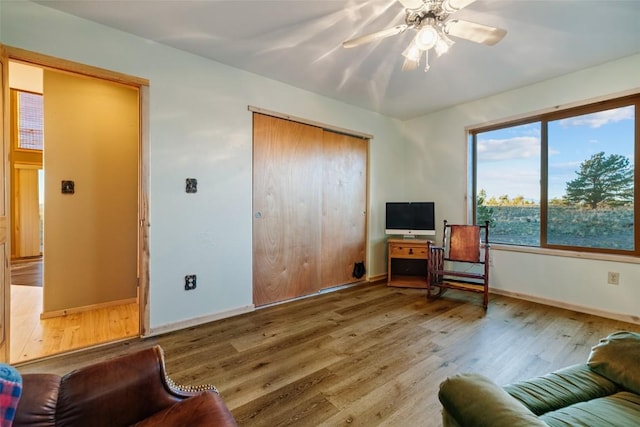 sitting room featuring hardwood / wood-style flooring and ceiling fan