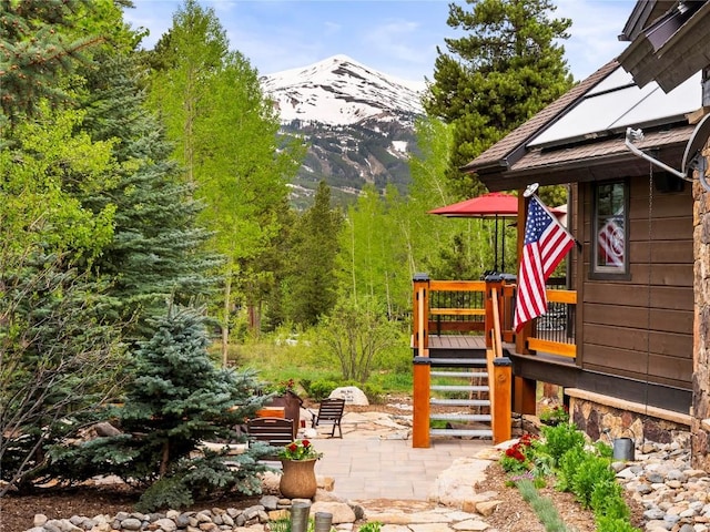 view of patio with a deck with mountain view