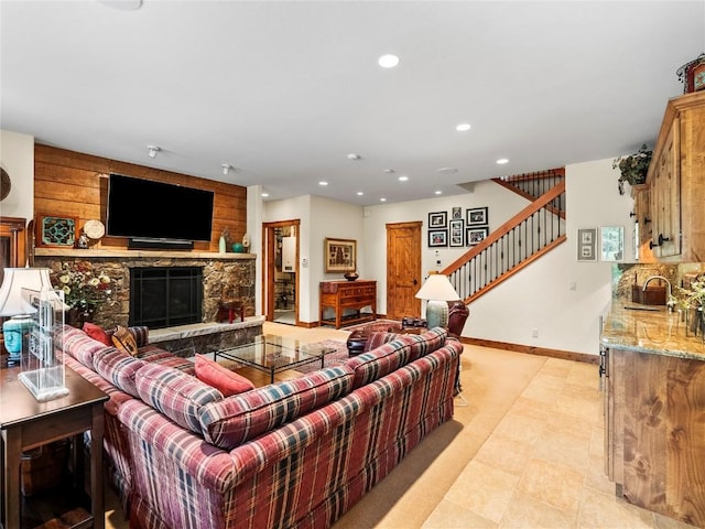 living room with a fireplace, sink, and light tile patterned flooring