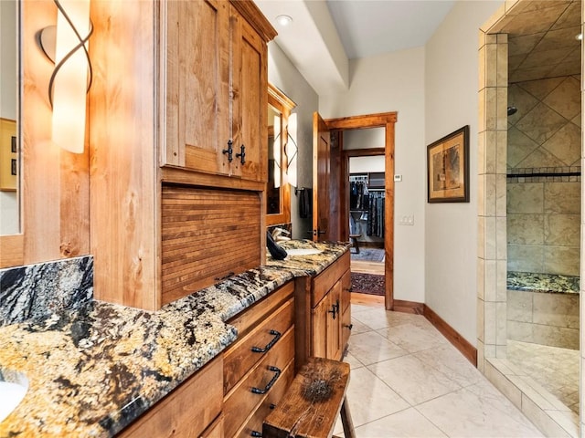 interior space featuring vanity and tiled shower